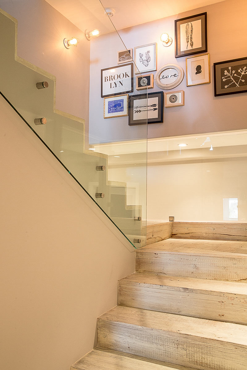 modern-stairs-distressed-wood-gallery-wall-landing-plexiglass-railing-benedetta-amadi-homepolish-sf